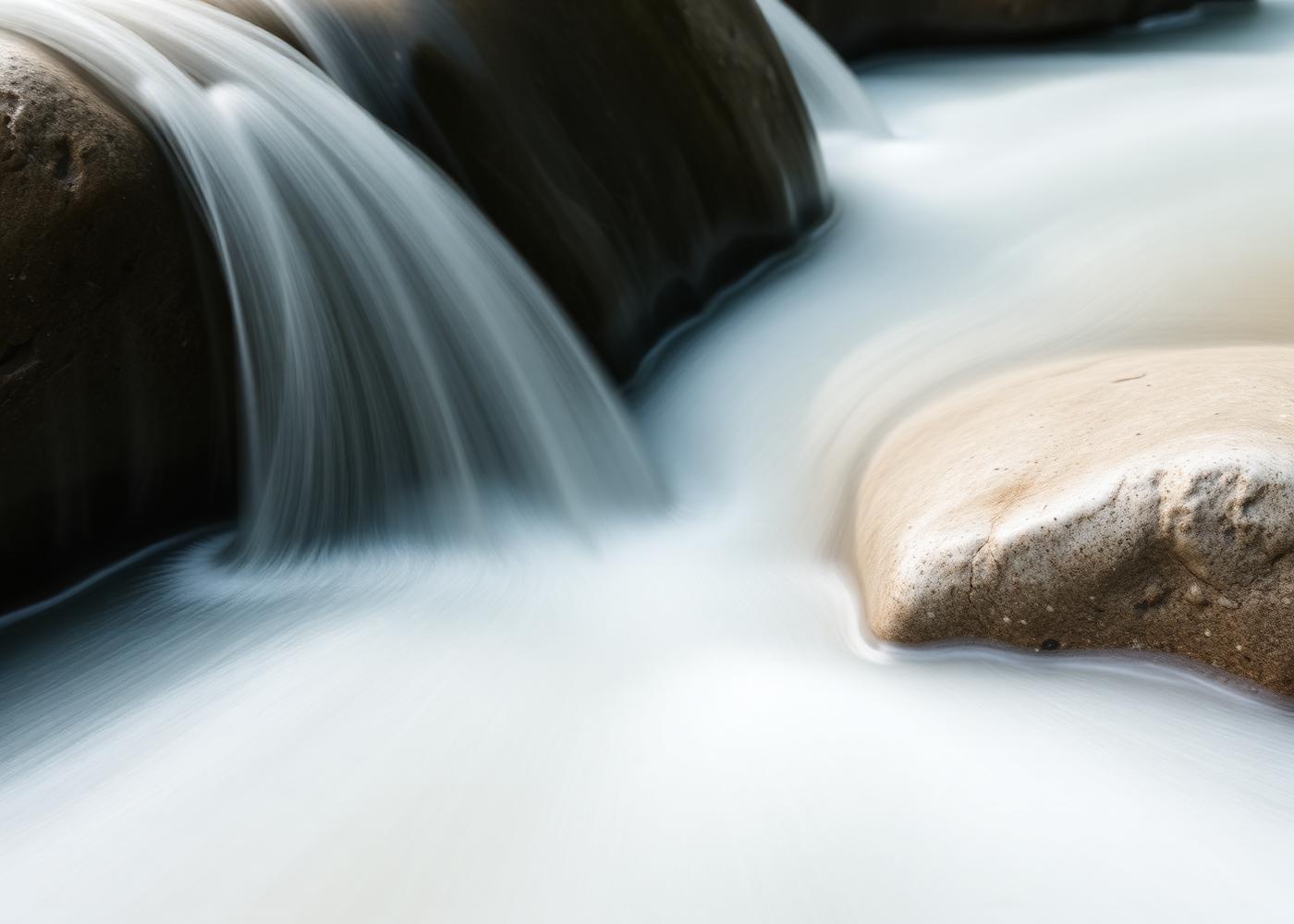 Spring water flowing over smooth stones